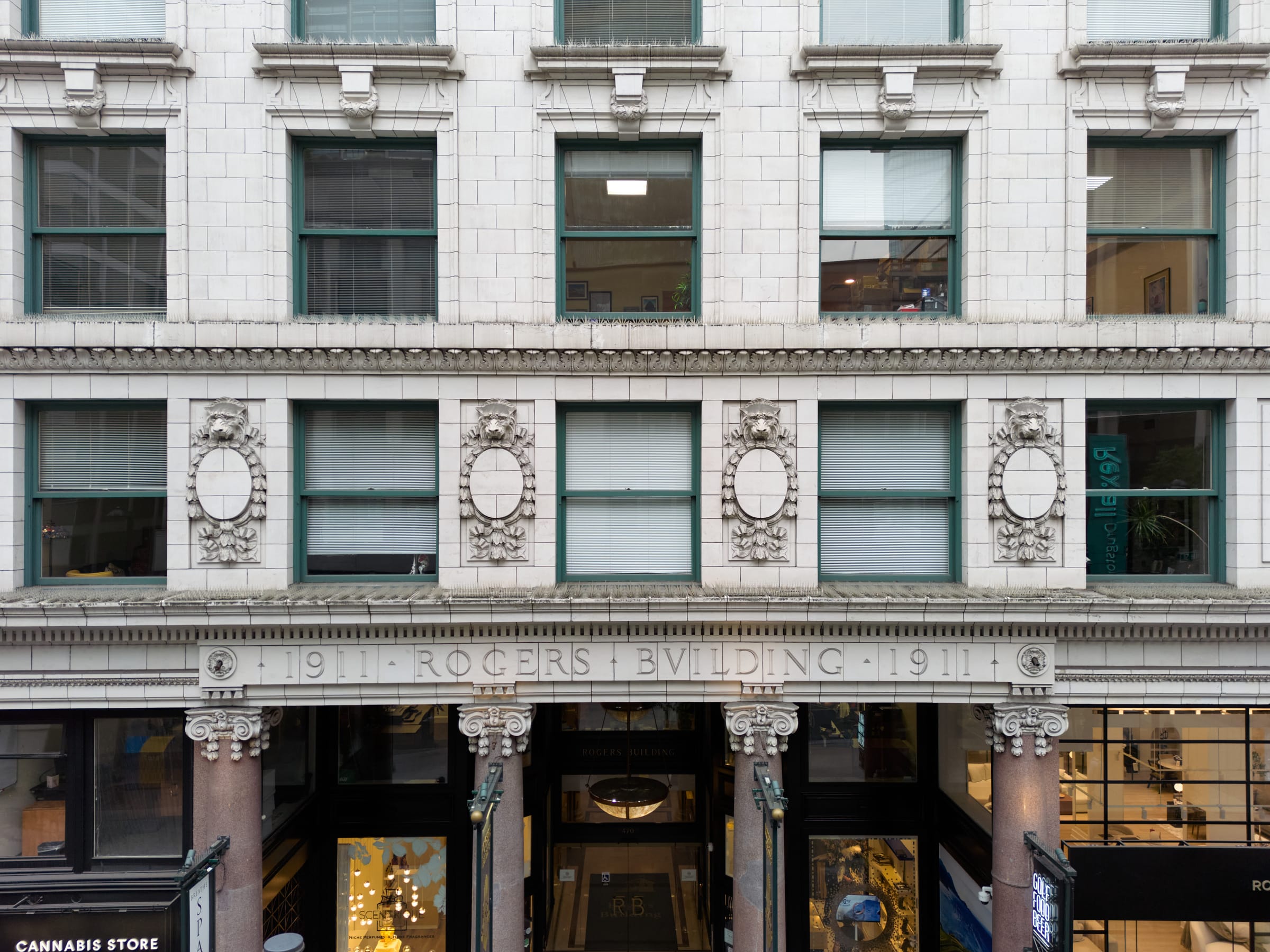 The Rogers Building façade with its carved inscription and lion-head cartouches