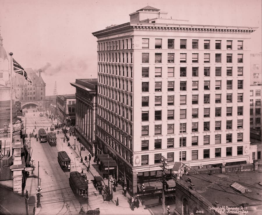1913 photograph of the Rogers Building with streetcars on Granville Street