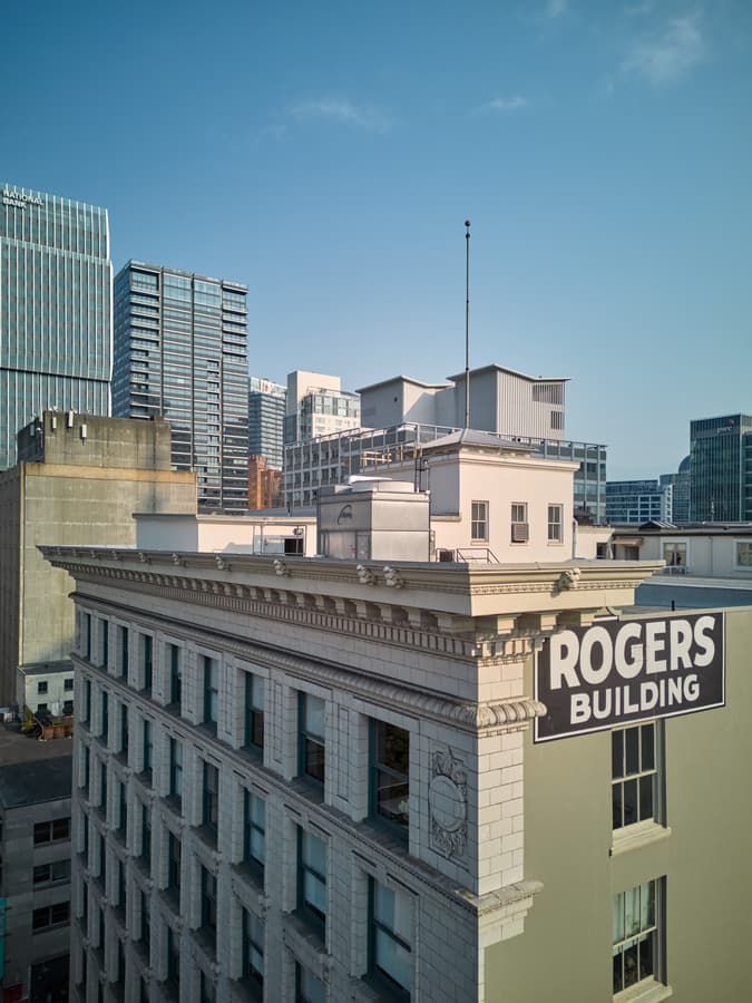 Aerial view of the Rogers Building cornice with modern towers behind